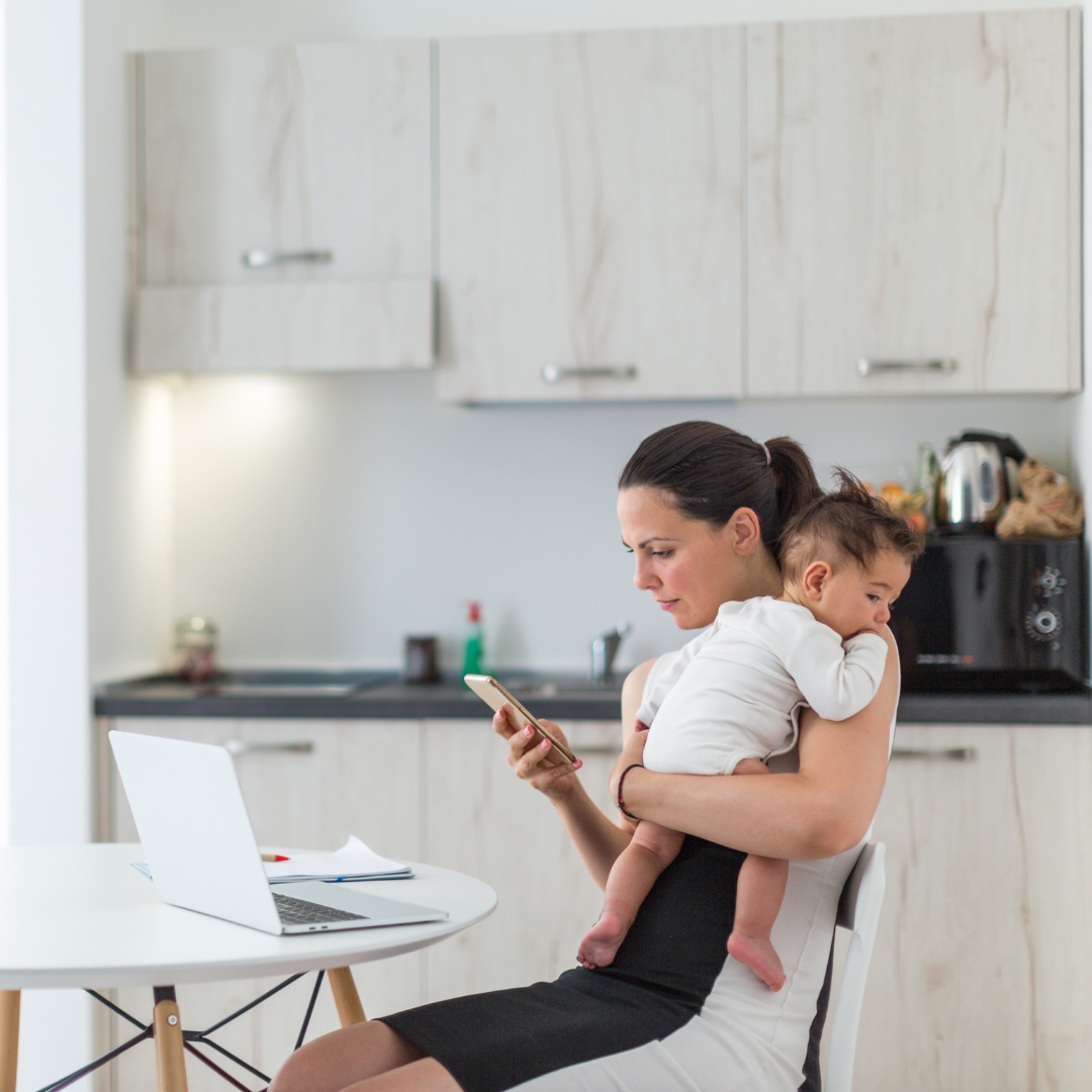 Busy business owner with baby, working remotely and managing commercial laundry needs.