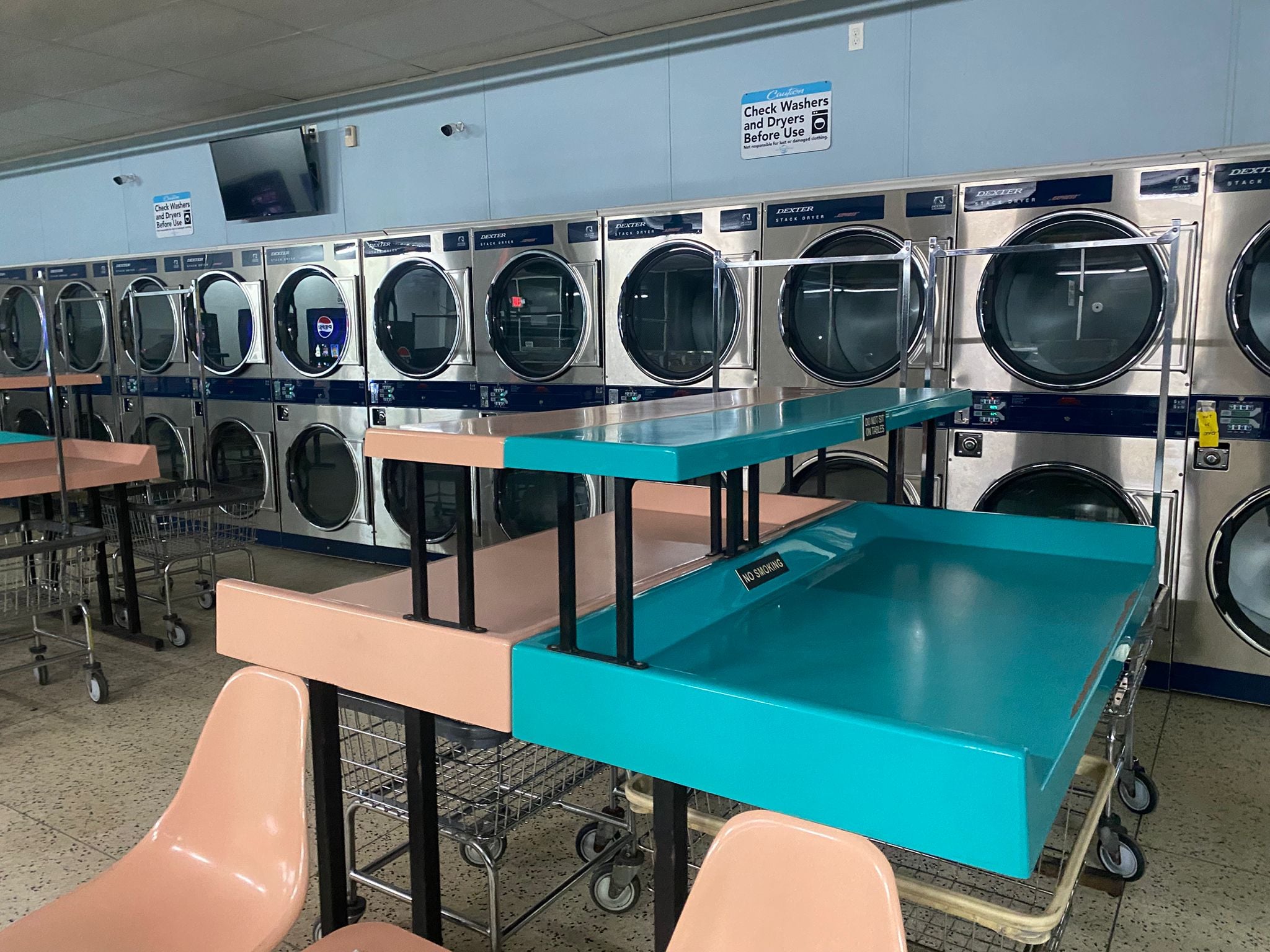 Sprinkle Laundry Portage Michigan: rows of Dexter washers and dryers with folding tables for moving day convenience.